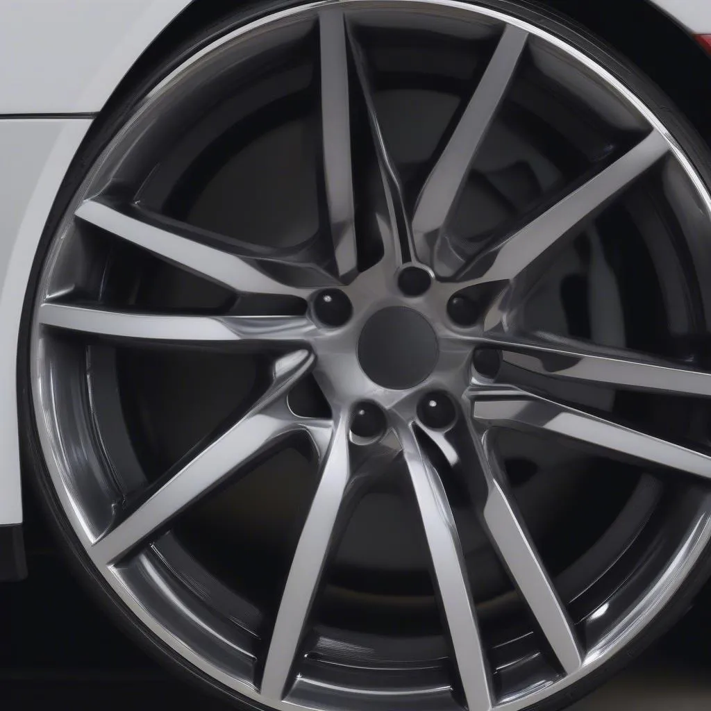 A close-up of black rims on a gray car