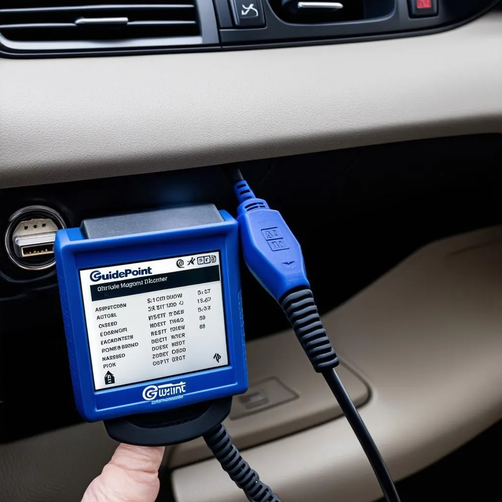 Guidepoint OBD Scanner plugged into a car's OBD-II port